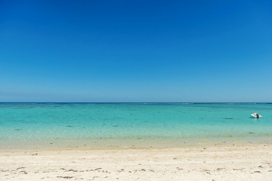 Experience the breathtaking beauty of Flic en Flac Beach with this stunning image showcasing the crystal-clear turquoise waters and soft white sands of Mauritius. Perfect for those seeking a tranquil beachfront escape at Cap Ouest Mauritius, this photo captures the idyllic scenery of the island's west coast, inviting visitors to relax and enjoy the serene tropical paradise.